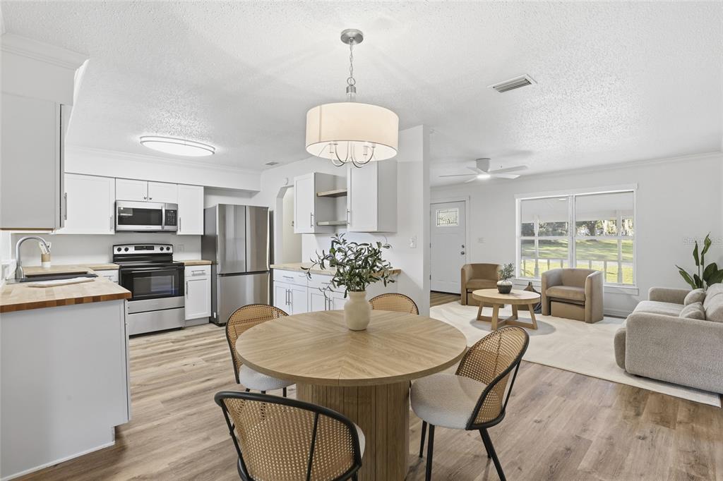 331 Northeast 2nd Street Williston, FL 32696 - Photo 9 of 29 a view of a dining room with furniture and wooden floor