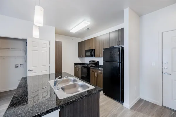 a kitchen with a refrigerator stove and sink
