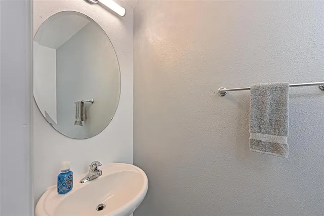 a bathroom with a sink and mirror