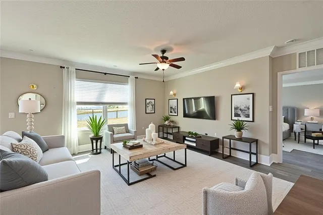 a living room with furniture and wooden floor