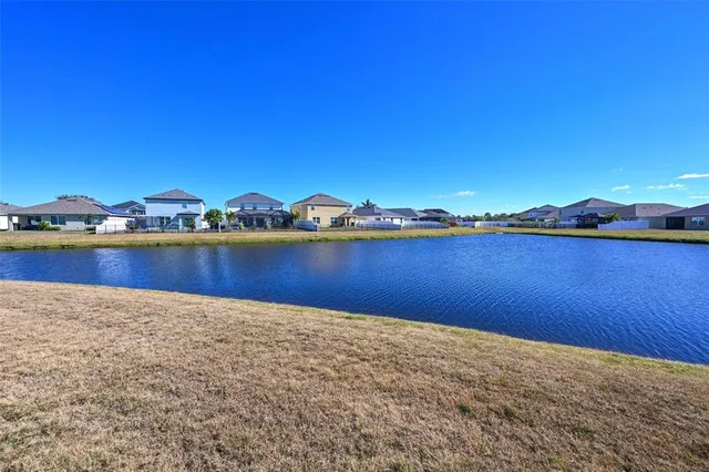 a view of a lake with houses in the background
