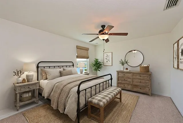 a bedroom with bed and a chandelier
