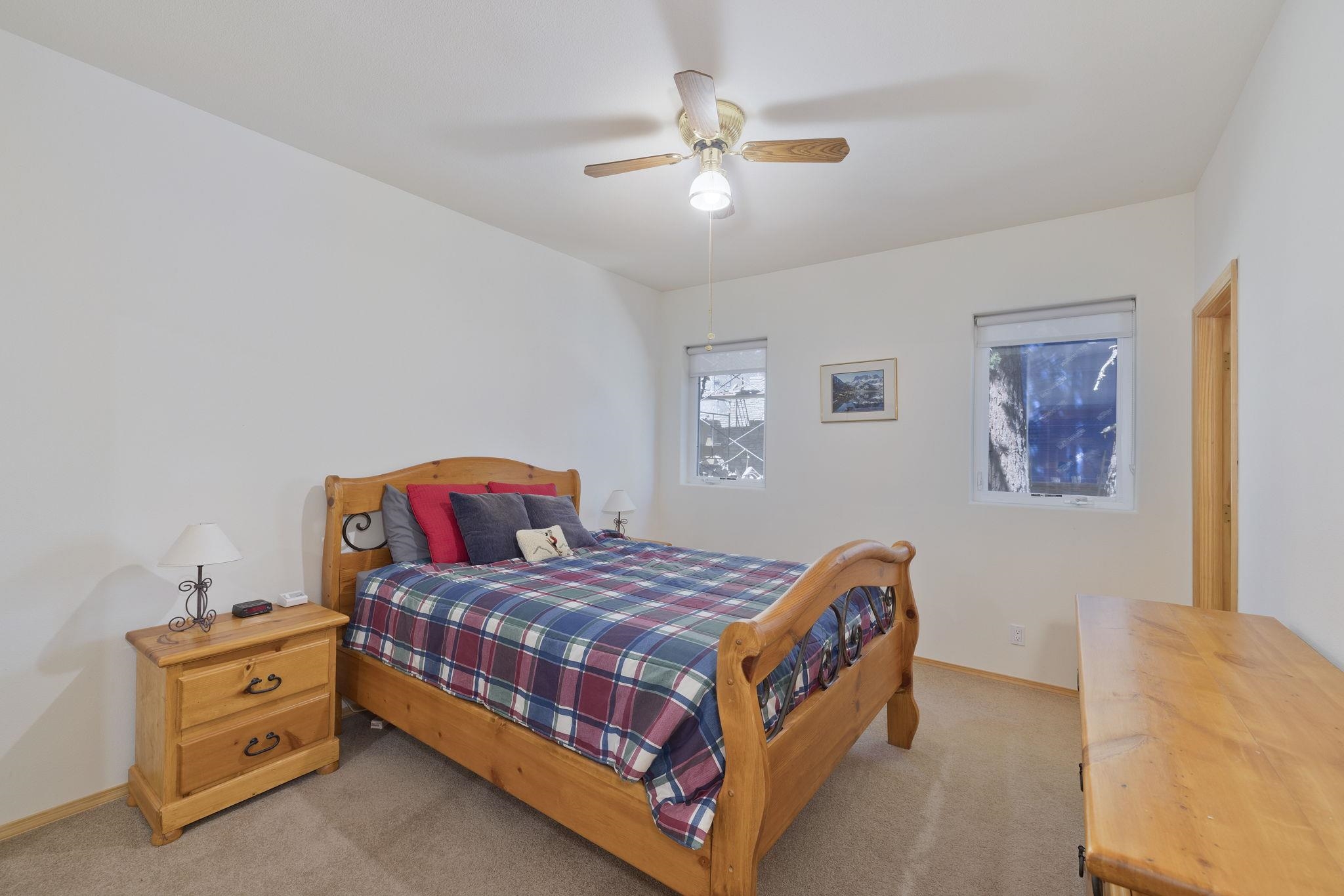 492 John Muir Road Mammoth Lakes, CA 93546 - Photo 23 of 33 Neutral wall color, two windows, ceiling fan, and carpeted flooring
