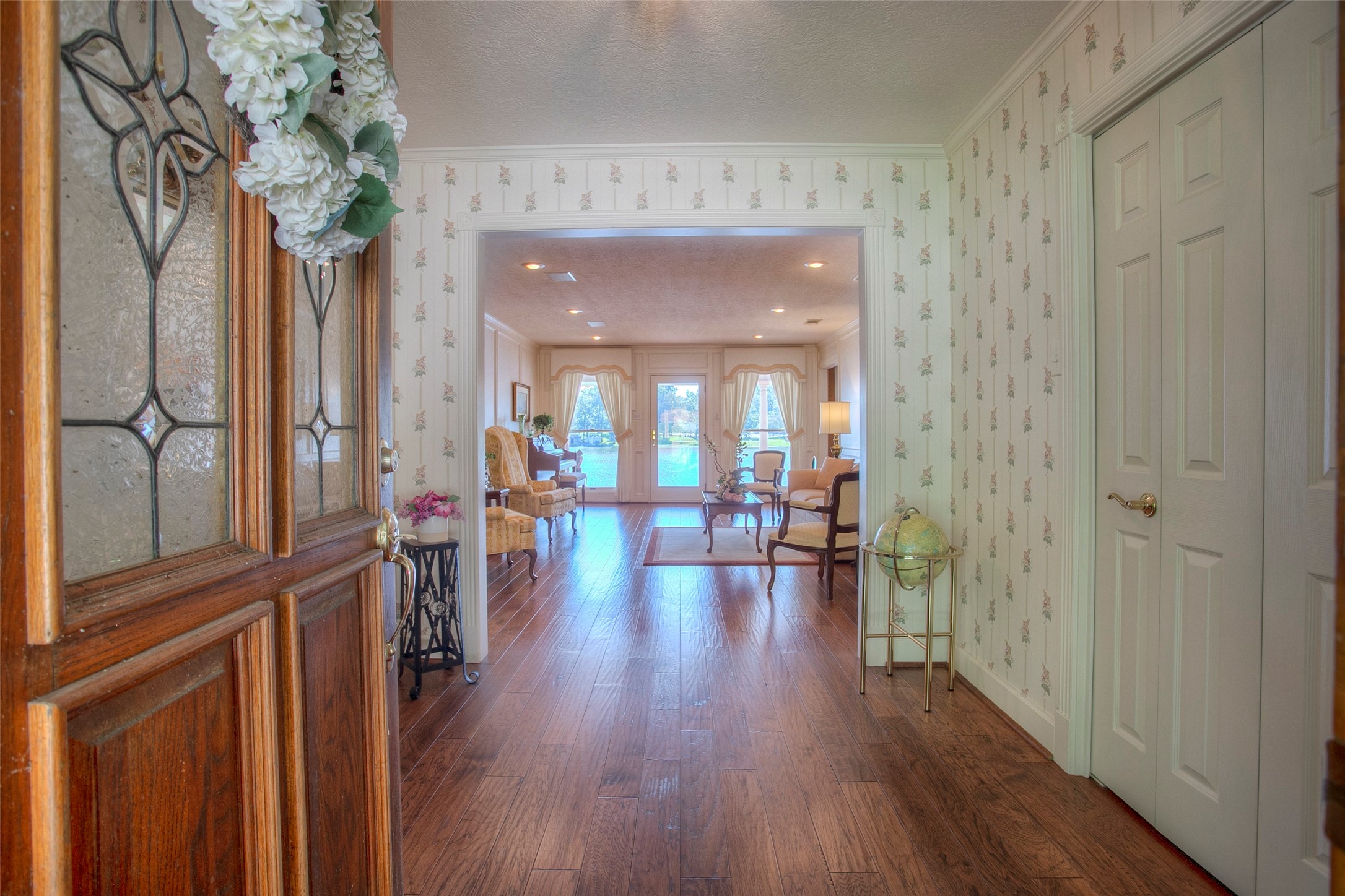 2008 Wickersham Drive Huntsville, TX 77340 - Photo 15 of 49 a hallway with wooden floor chandelier and livingroom view
