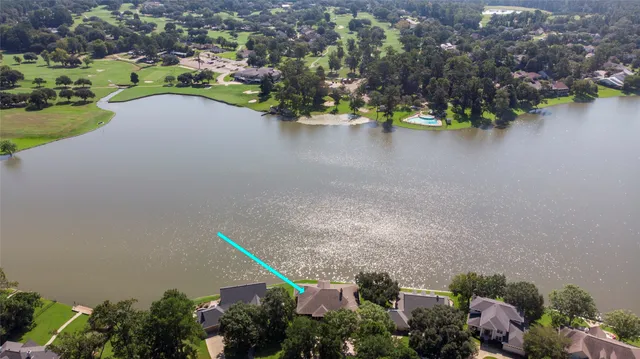an aerial view of a house with a lake view