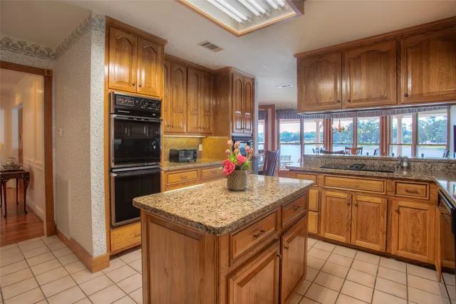 a kitchen with granite countertop stainless steel appliances and wooden cabinets