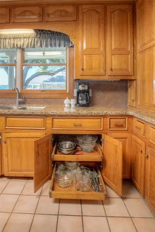 a kitchen with a sink and cabinets