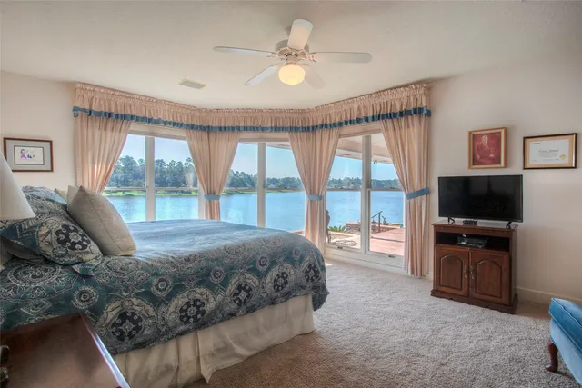 a bedroom with a bed and glass door