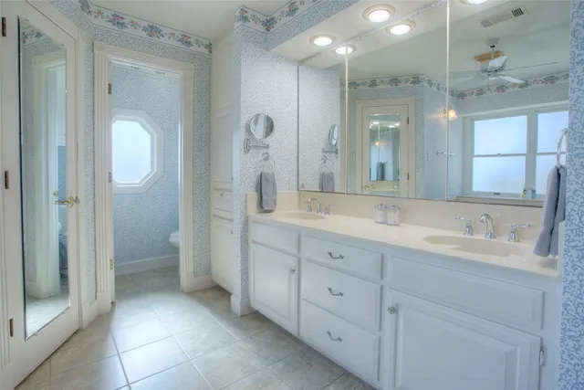 a spacious bathroom with a double vanity sink mirror and double
