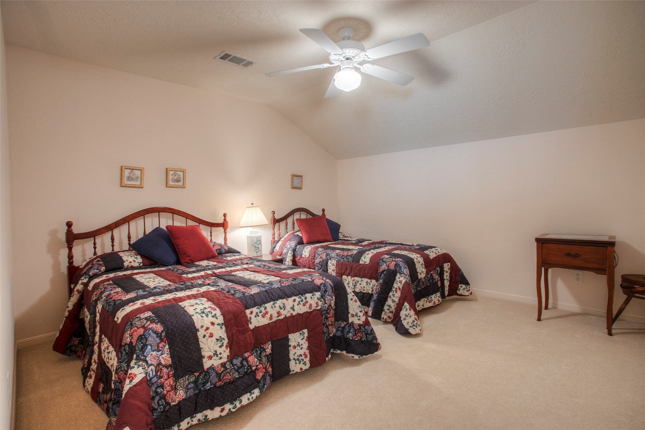 2008 Wickersham Drive Huntsville, TX 77340 - Photo 43 of 49 a bedroom with two beds and a chandelier