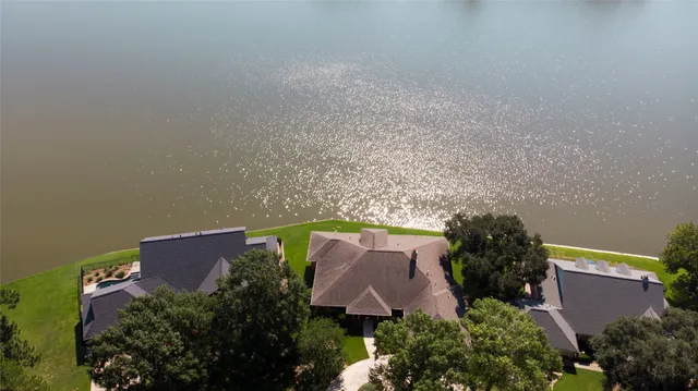 an aerial view of a house with plants and large trees