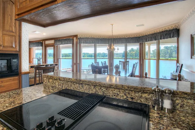 a living room with furniture and floor to ceiling windows