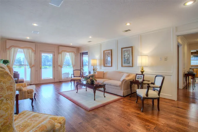 a living room with furniture and a wooden floor