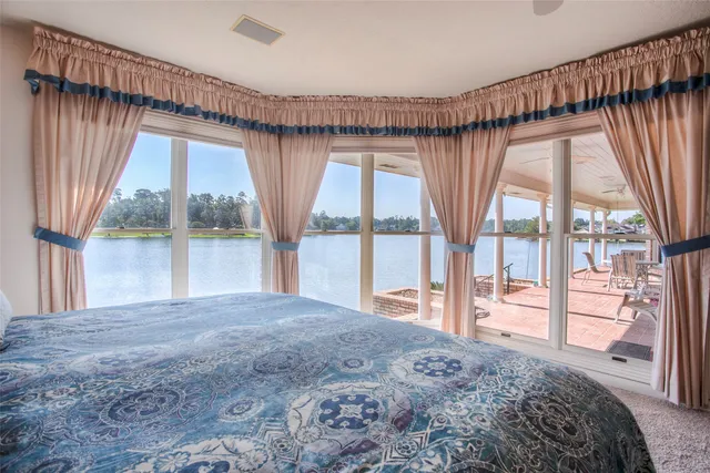 a bedroom with a large bed and a large window