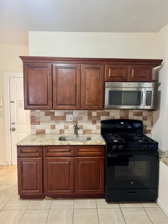 a kitchen with stainless steel appliances a stove and a microwave
