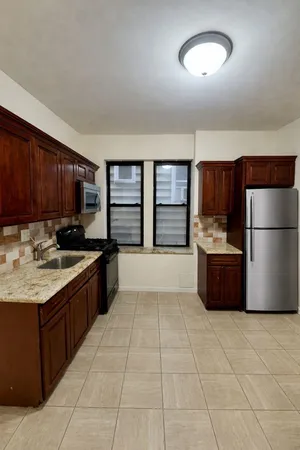 a kitchen with stainless steel appliances granite countertop a refrigerator and a sink