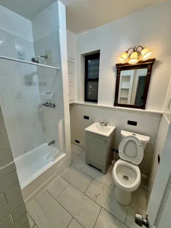 a bathroom with a toilet sink and shower