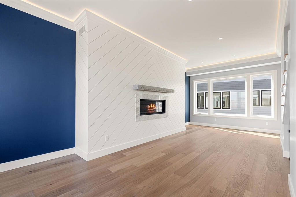 312 Newton Street, Unit 1A Waltham, MA 02453 - Photo 14 of 32 a view of an empty room with wooden floor and a window