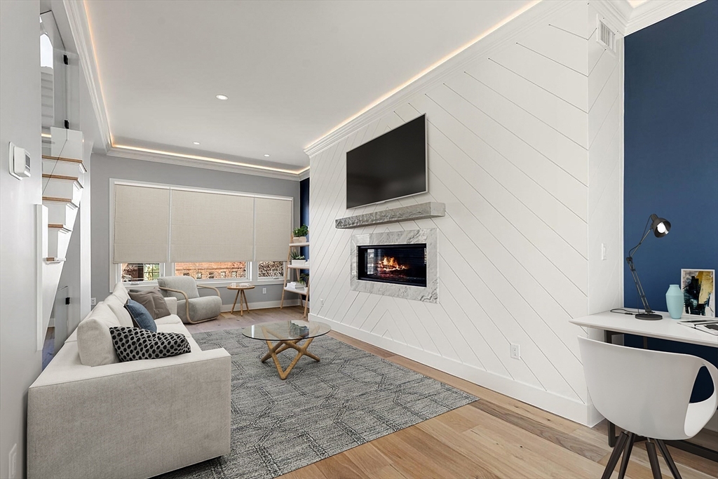 312 Newton Street, Unit 1A Waltham, MA 02453 - Photo 15 of 32 a living room with furniture and a flat screen tv