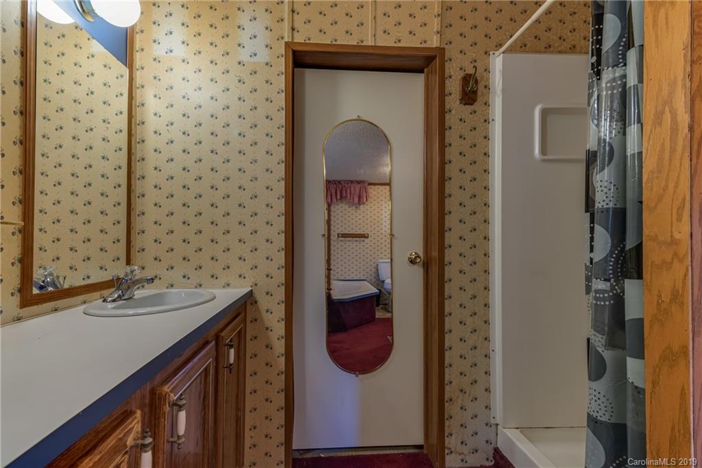 404 Whiteside Road Rutherfordton, NC 28139 - Photo 14 of 18 a bathroom with a sink and a mirror