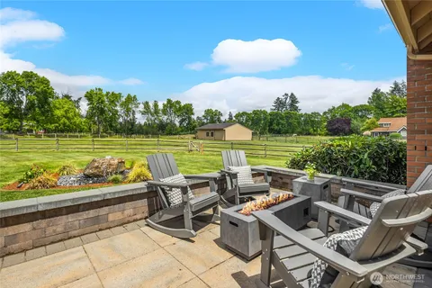 a view of swimming pool with outdoor seating and plants