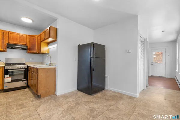 a view of kitchen with stove and refrigerator