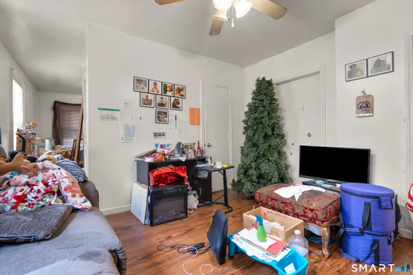 a bed room with furniture and a flat screen tv
