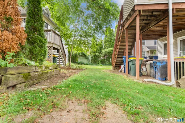 a view of a house with backyard and sitting area