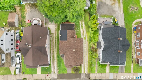 aerial view of a house with a tree next to a yard