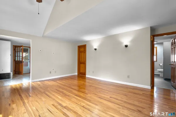 wooden floor in an empty room with a window