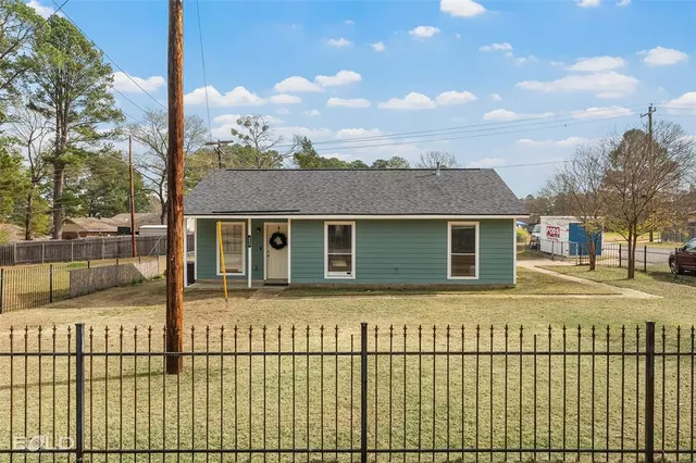 a front view of a house with a fence