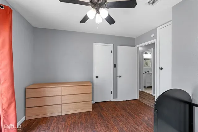 a bedroom with a bed and a ceiling fan