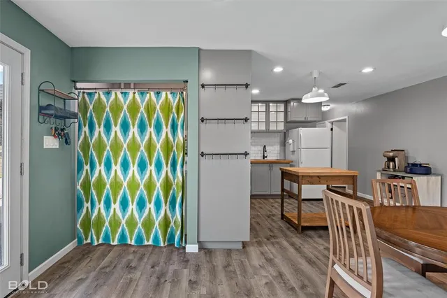 a kitchen with stainless steel appliances granite countertop a refrigerator and a table