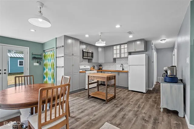 a kitchen with refrigerator cabinets dining table and chairs
