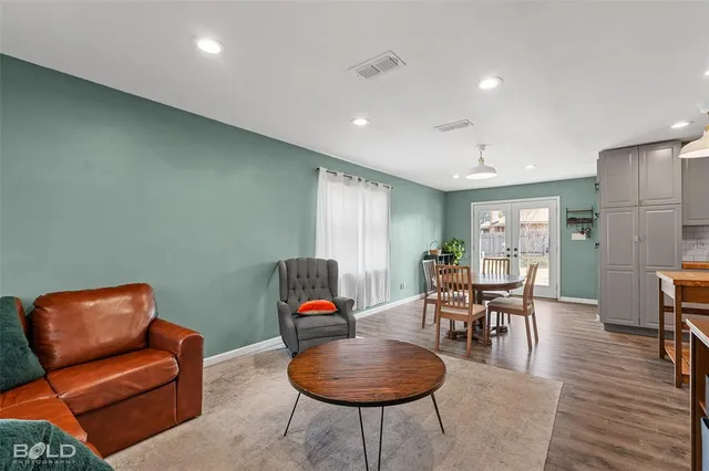a living room with furniture and wooden floor