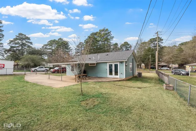 a view of a house with backyard porch and sitting area
