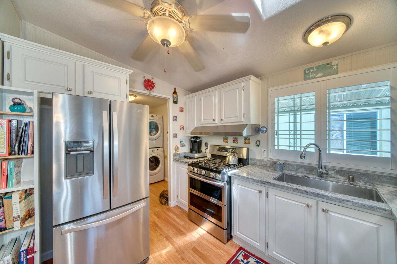 5 Lighthouse Road, Unit 5 Half Moon Bay, CA 94019 - Photo 12 of 25 a kitchen with stainless steel appliances a refrigerator sink and cabinets
