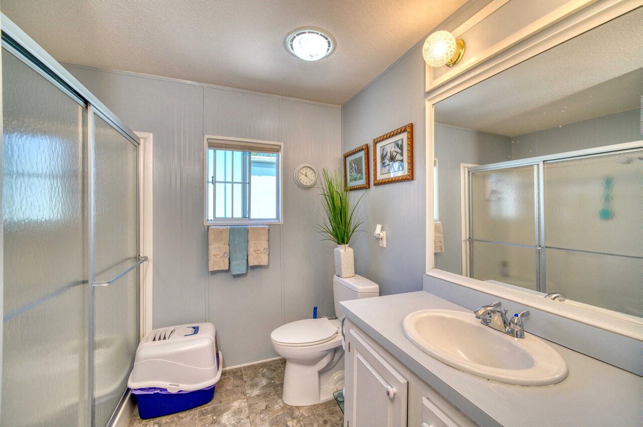 5 Lighthouse Road, Unit 5 Half Moon Bay, CA 94019 - Photo 15 of 25 a bathroom with a granite countertop sink toilet and shower