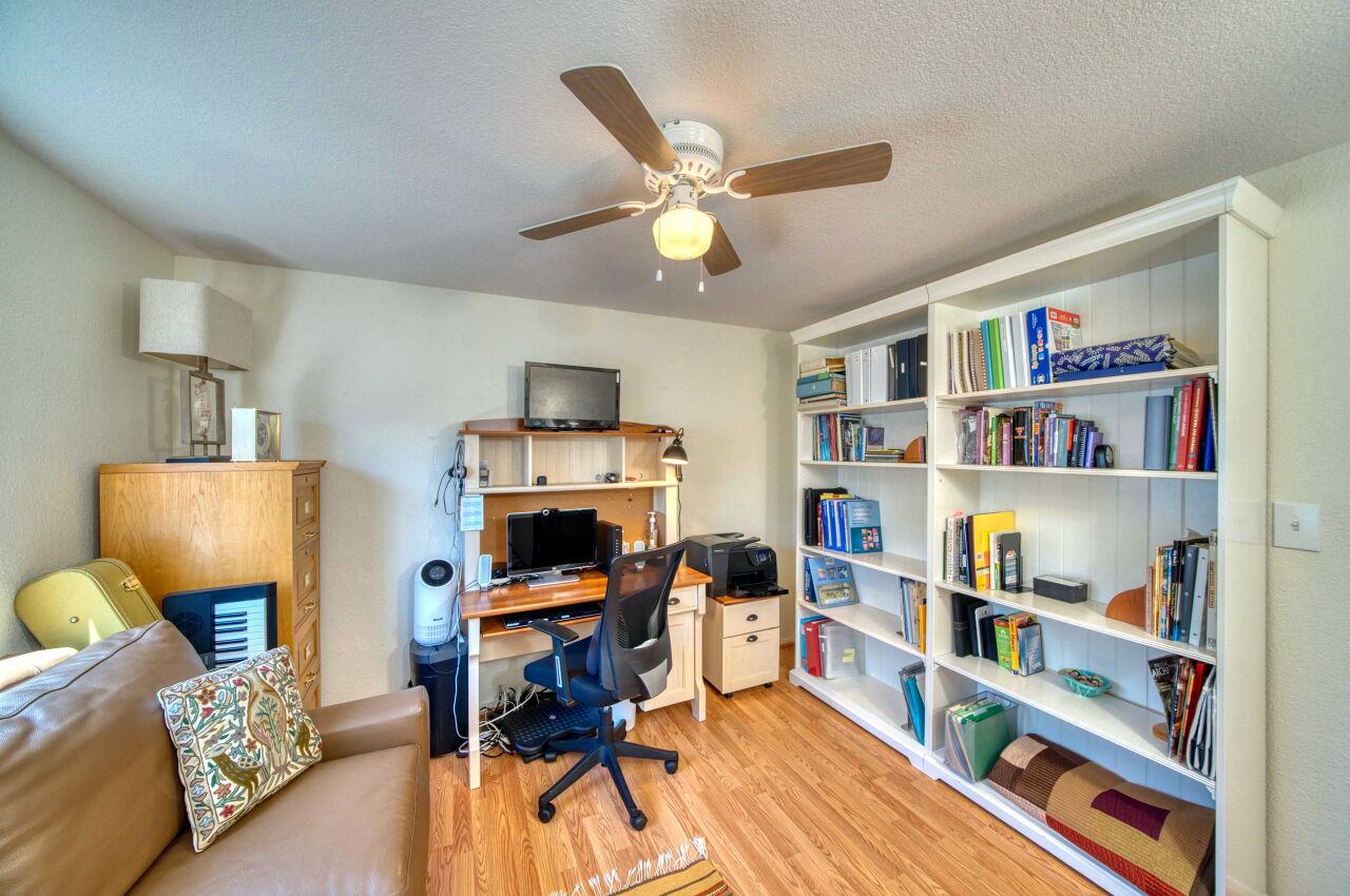 5 Lighthouse Road, Unit 5 Half Moon Bay, CA 94019 - Photo 17 of 25 a living room with furniture and a book shelf