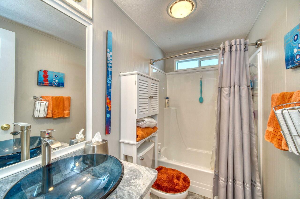 5 Lighthouse Road, Unit 5 Half Moon Bay, CA 94019 - Photo 19 of 25 a bathroom with a granite countertop sink and a mirror