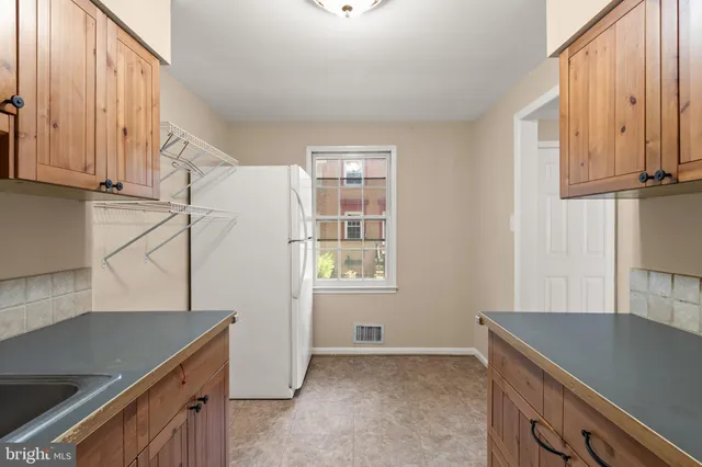 a kitchen with stainless steel appliances granite countertop a sink a stove and a refrigerator