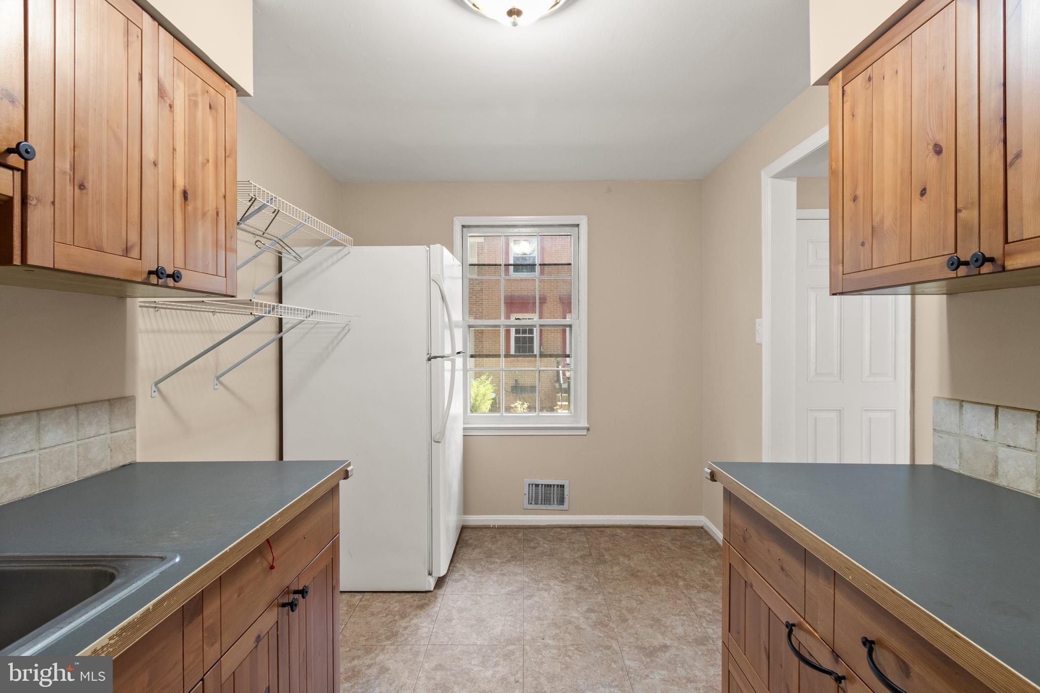 13143 Putnam Circle Woodbridge, VA 22191 - Photo 12 of 38 a kitchen with stainless steel appliances granite countertop a sink a stove and a refrigerator