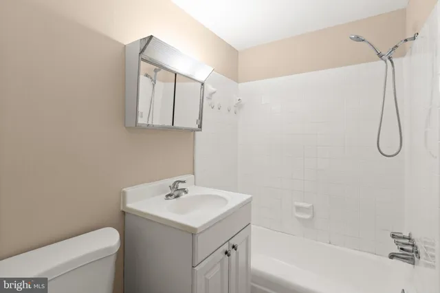 a bathroom with a sink a toilet and a bathtub