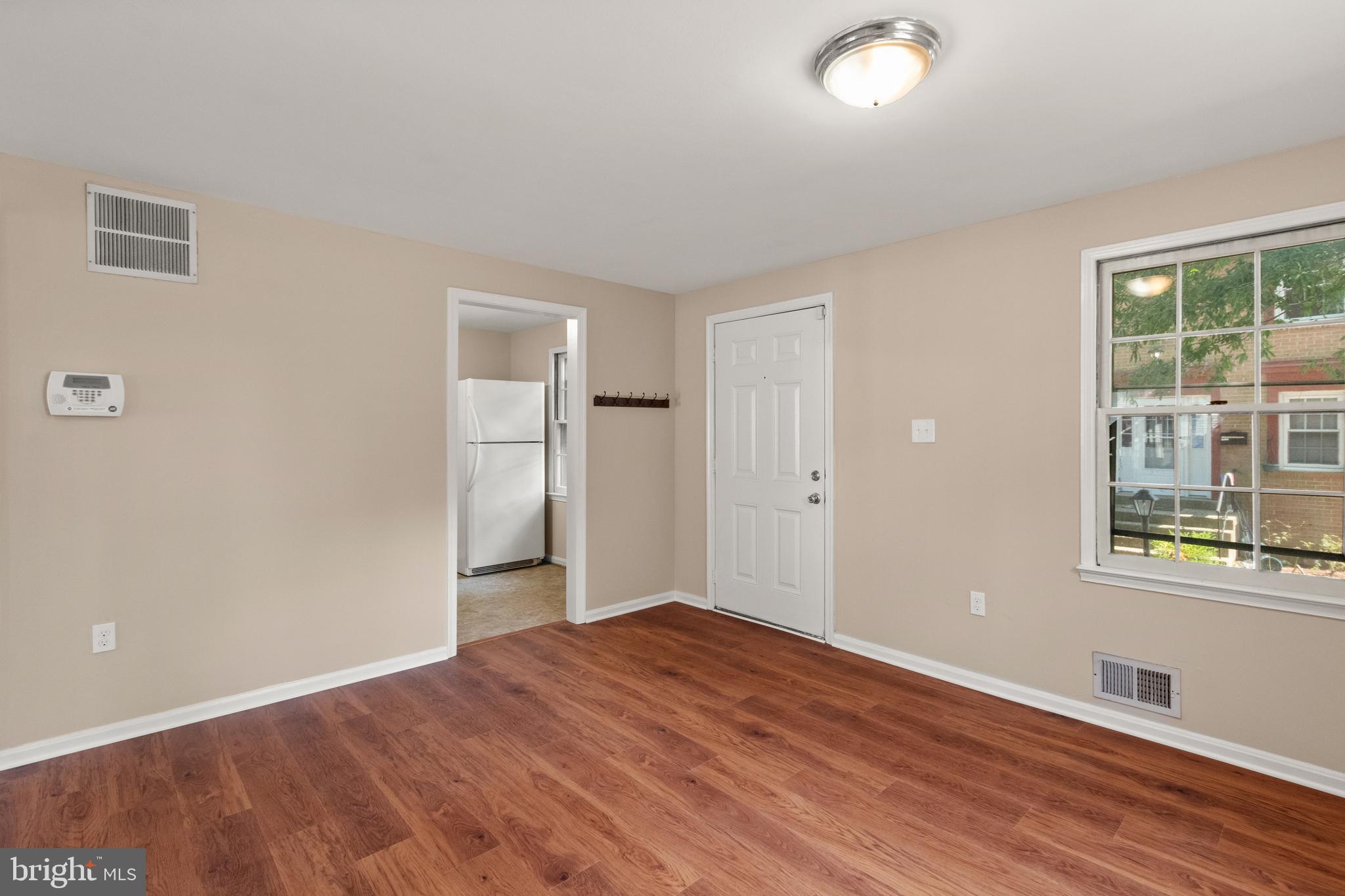 13143 Putnam Circle Woodbridge, VA 22191 - Photo 5 of 38 an empty room with wooden floor and windows