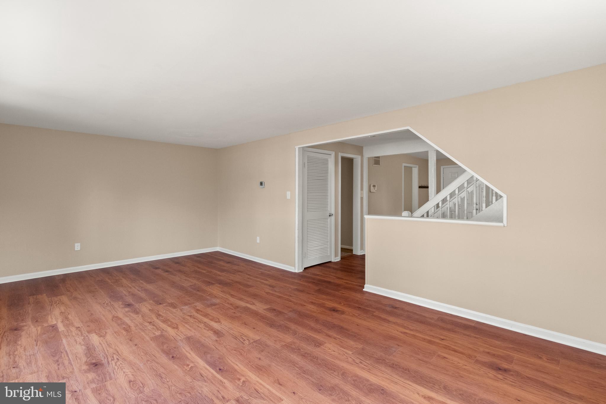 13143 Putnam Circle Woodbridge, VA 22191 - Photo 8 of 38 a view of an empty room with wooden floor and a window