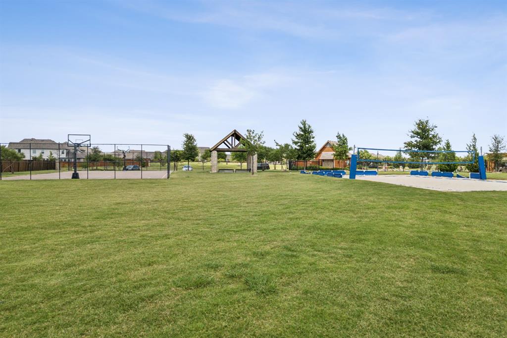 1014 Dunhill Lane Forney, TX 75126 - Photo 34 of 38 Community green space featuring a manicured lawn, a basketball court, a sand volleyball court, and a covered pavilion