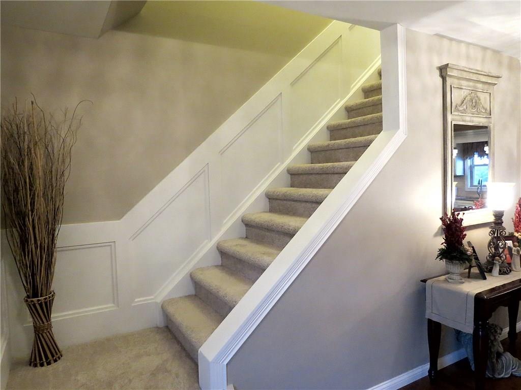 175 Cedar Ridge Drive Monaca, PA 15061 - Photo 14 of 25 New carpeting and character details such as the judges paneling guide the way to the second floor.