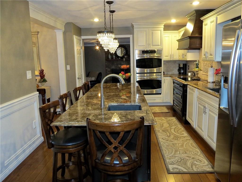 175 Cedar Ridge Drive Monaca, PA 15061 - Photo 5 of 25 Beautiful pendent lighting lends style & sophistication to the room while a double oven, electric cook top & 2 granite composite sinks w/high profile faucets deliver functionality to a true Chefs Kitchen!