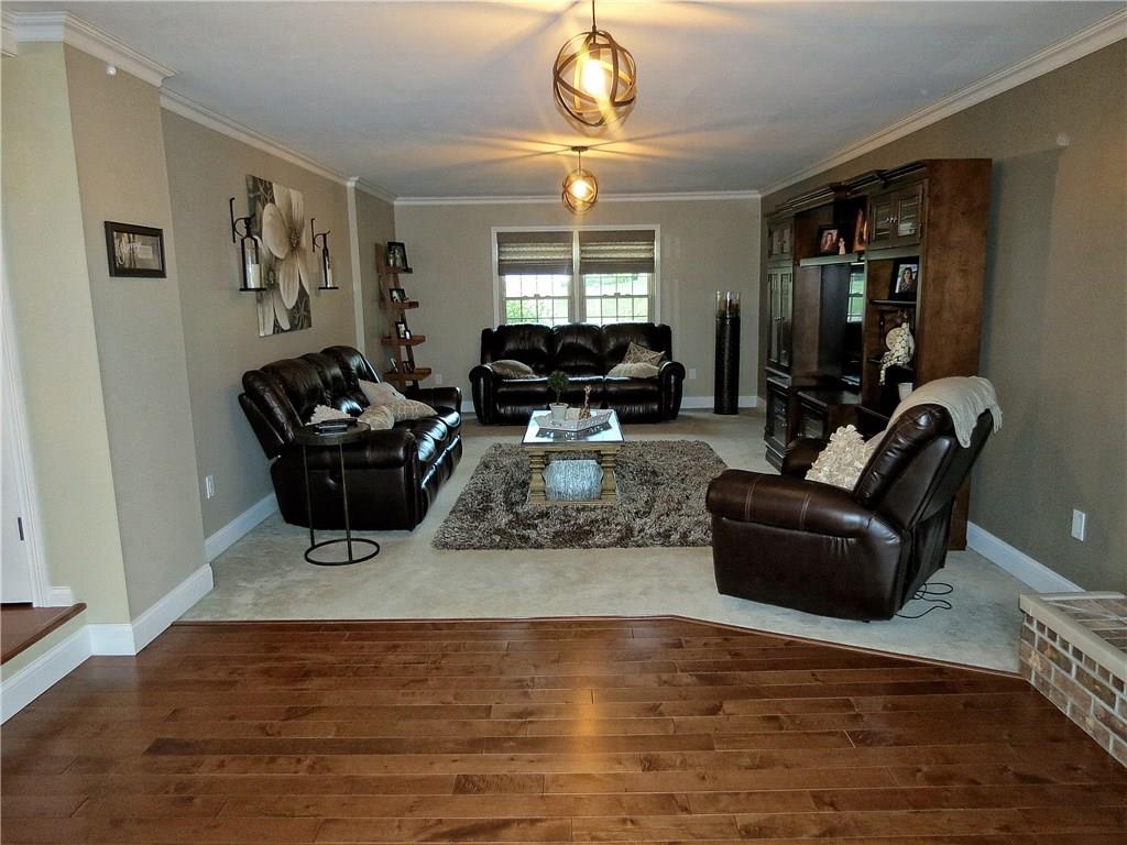 175 Cedar Ridge Drive Monaca, PA 15061 - Photo 9 of 25 A brick fireplace, new carpet, maple hardwood floors, crown molding & chic fixtures combine to give this room distinct style!