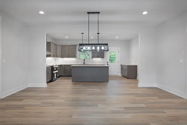 a large kitchen with stainless steel appliances granite countertop a granite counter tops and a view of kitchen